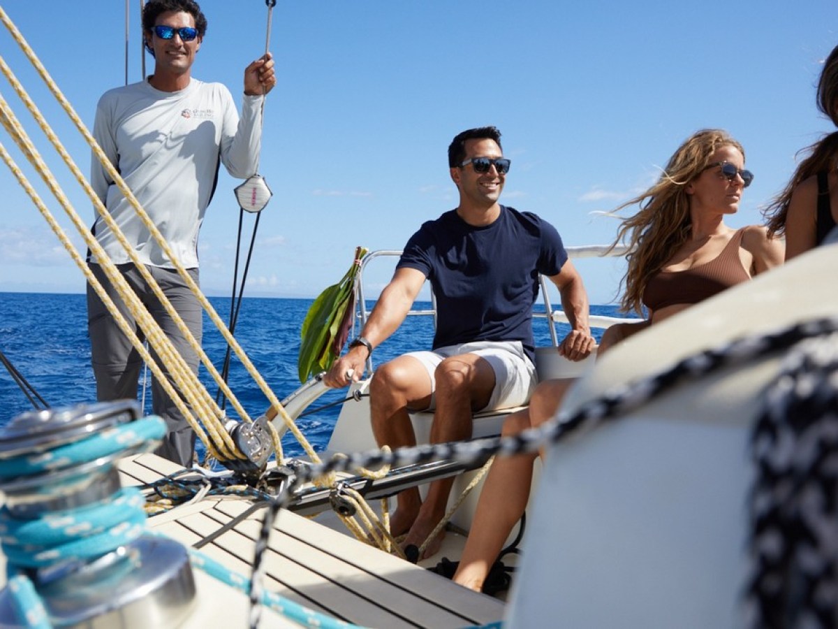 a couple of people riding on the back of a boat