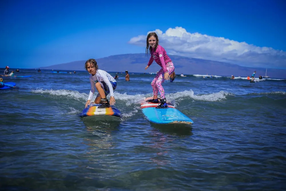 child catching a wave in Maui